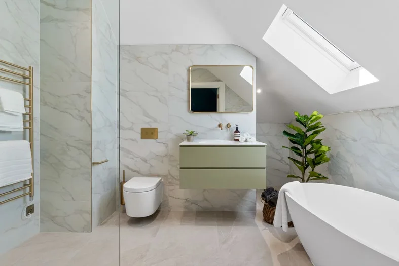 Top-floor bathroom with a bath beneath the roof light